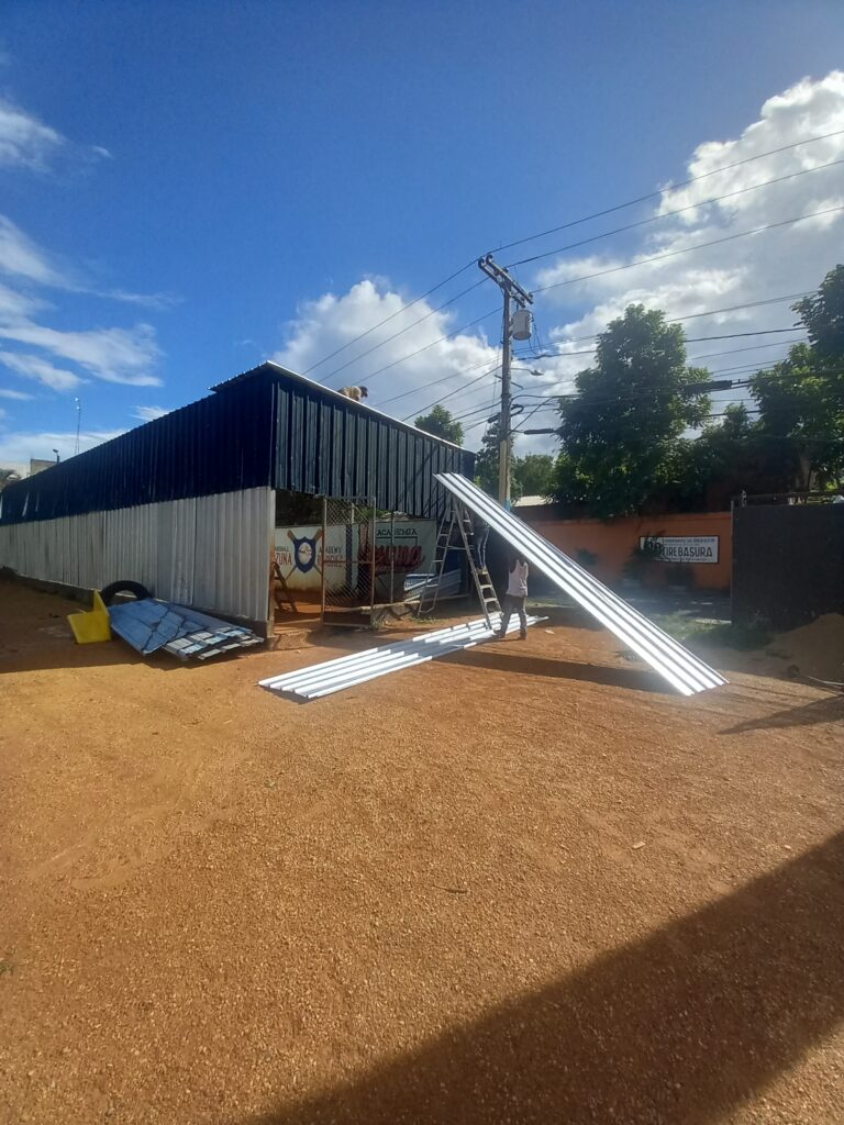 Baseball without borders building a new roof for the baseball cage in Boca Chica.
